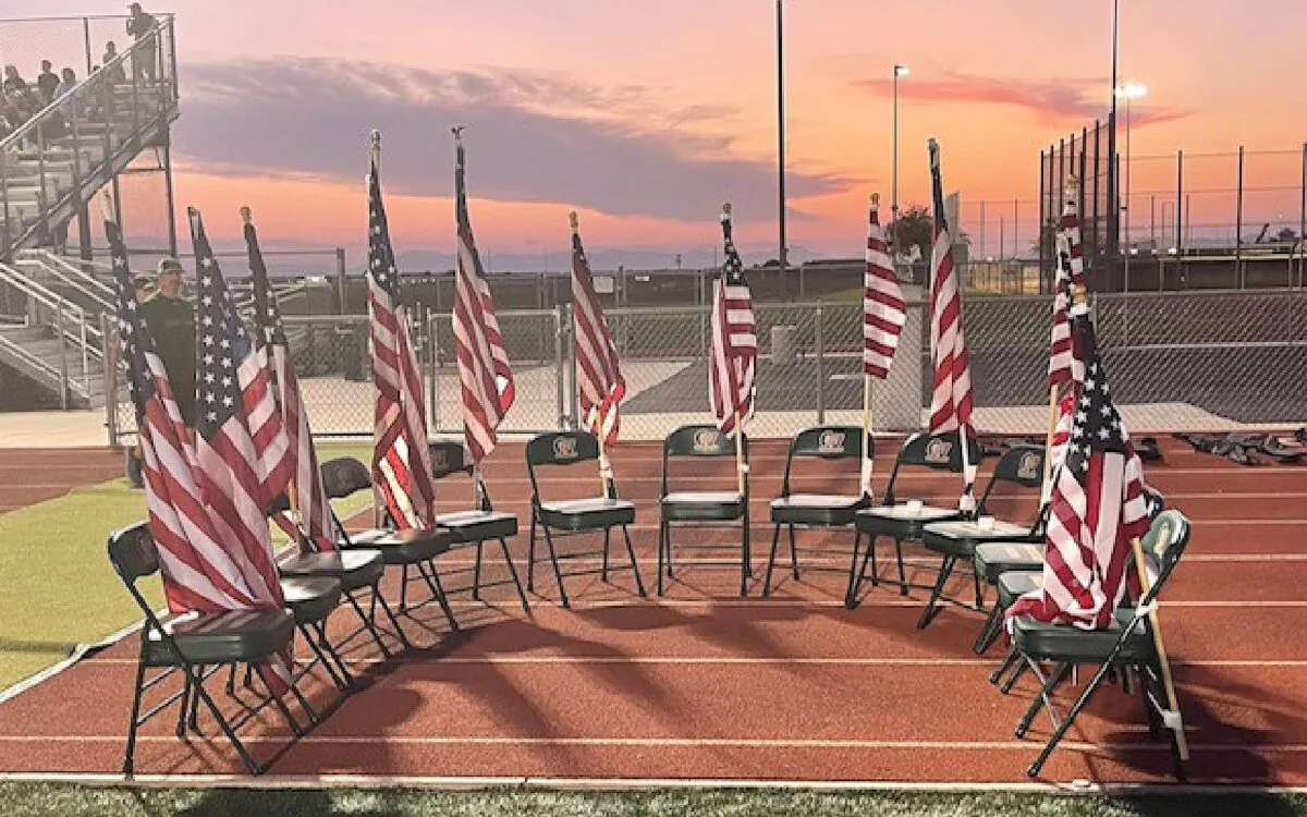 Campo Verde High School varsity football team carried 13 American flags to the field to honor the 13 service members killed Aug. 26 in Afghanistan. Kathleen Diggs, counselor and community service coordinator at Campo Verde, said the flags were then set up near the field with 13 empty chairs. (Zach Alvira on Twitter)