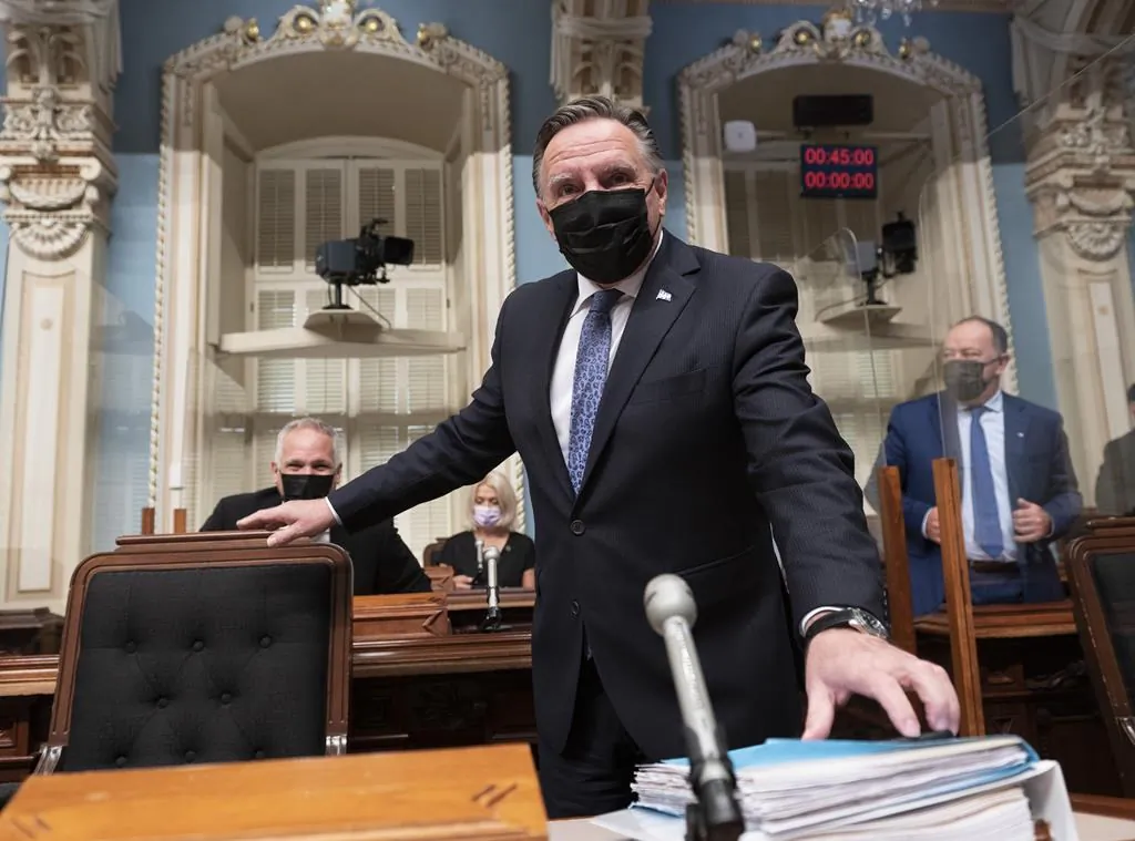 Quebec Premier Francois Legault walks in for question period on September 23, 2021 at the legislature in Quebec City. Quebec Health Minister Christian Dube, right, looks on. The Quebec government will present offers to nurses to bring them back into the health system later in the day. (The Canadian Press/Jacques Boissinot)