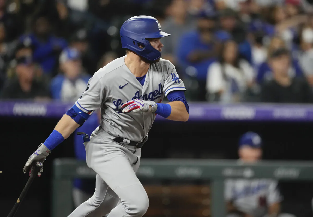 Los Angeles Dodgers’ Gavin Lux follows the flight of his RBI-double off Colorado Rockies starting pitcher German Marquez in the fourth inning of a baseball game in Denver on Sept. 22, 2021. (AP Photo/David Zalubowski)
