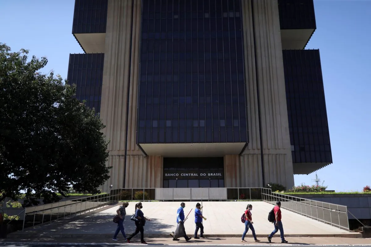 People walk in front the Central Bank headquarters building in Brasilia, Brazil on Aug. 25, 2021. (Amanda Perobelli/Reuters)