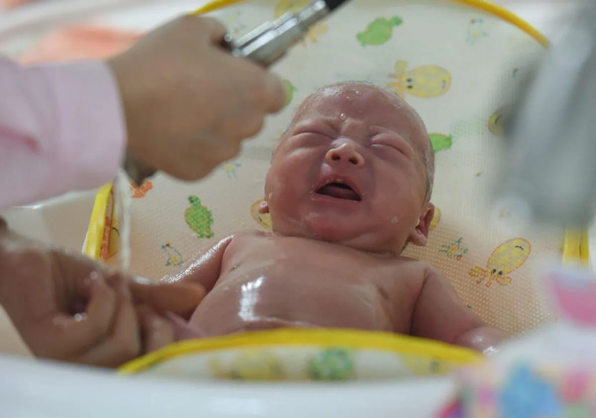 This photo taken on January 19, 2019 shows a medical staff taking care of a new born baby at a hospital in Fuyang in China's eastern Anhui province. - China's population shrank last year for the first time in 70 years, experts said, warning of a "demographic crisis" that puts pressure on the country's slowing economy. (STR/AFP via Getty Images)