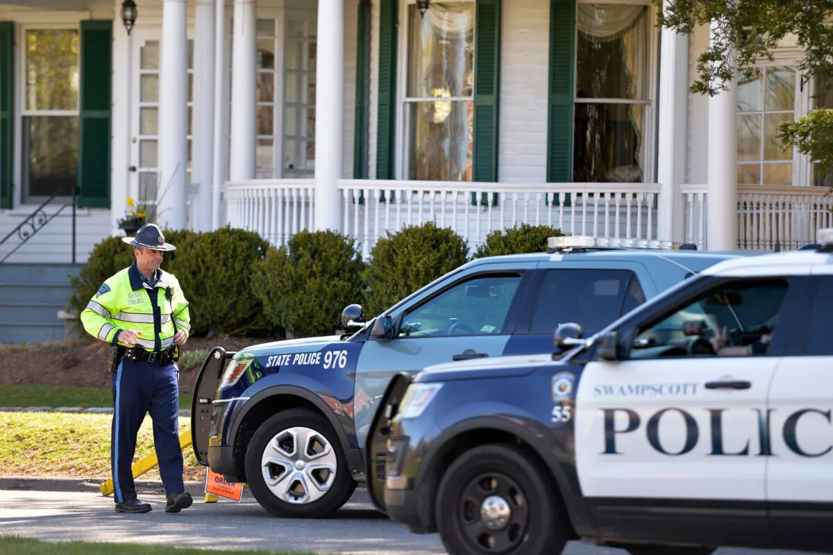 A state police officer stands guard outside the home of Massachusetts Governor Charlie Baker during a "Liberate Massachusetts" rally in Swampscott on April 23, 2020. (Joseph Prezioso/AFP via Getty Images)