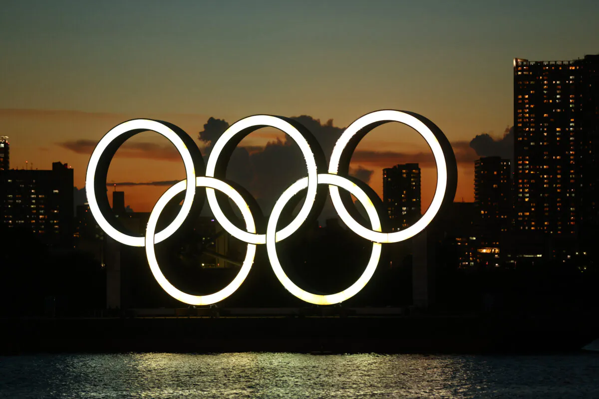 A general view of the Olympic rings installation and Rainbow Bridge as the sun sets on day twelve of the Tokyo 2020 Olympic Games at Odaiba Marine Park in Tokyo on Aug. 4, 2021. (Clive Rose/Getty Images)