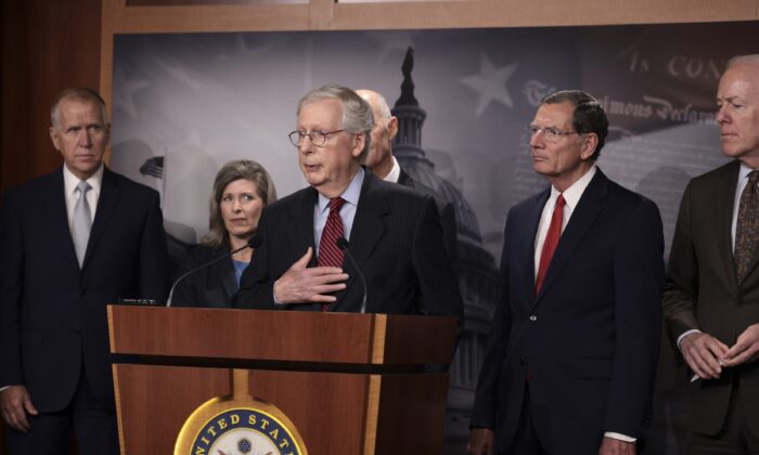 Senate Minority Leader McConnell (R-Ky.), center, speaks to reporters as other senators stand by, in Washington on Sept. 22, 2021. (Anna Moneymaker/Getty Images)