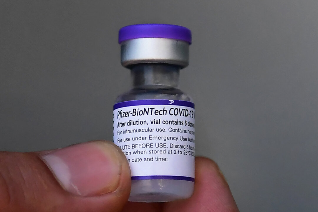 A 5-dose vial of the Pfizer COVID-19 vaccine is held in Los Angeles, Calif., on Sept. 21, 2021. (Frederic J. Brown/AFP via Getty Images)
