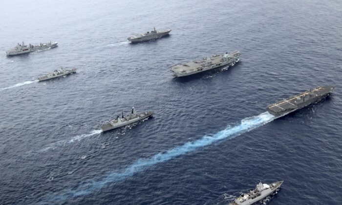 UK Royal Navy Carrier Strike Group 21 HMS Queen Elizabeth, HMS Defender, RFA Tidespring and HNLMS Evertsen from CSG21 sails with Japanese ships JS Izumo and JS Ise along with the Canadian ship HMCS Winnipeg in the Pacific Ocean, Sept. 2021. (UK Ministry of Defence via AP)