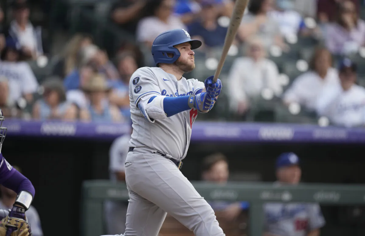 Los Angeles Dodgers' Max Muncy follows the flight of his two-run home run off Colorado Rockies relief pitcher Lucas Gilbreath in the 10th inning of a baseball game in Denver on Sept. 23, 2021. (AP Photo/David Zalubowski)