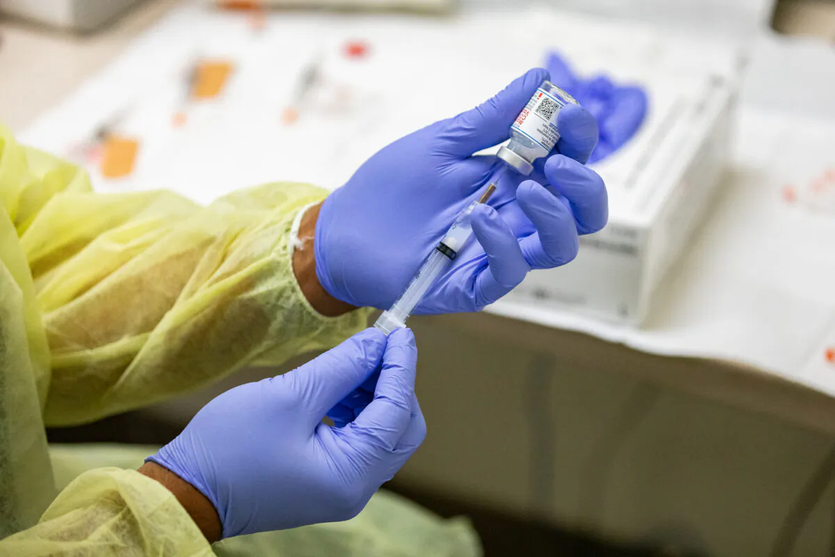 A health care worker prepares a Moderna COVID-19 vaccine at Lestonnac Health Clinic in Orange, Calif., on March 9, 2021. (John Fredricks/The Epoch Times)
