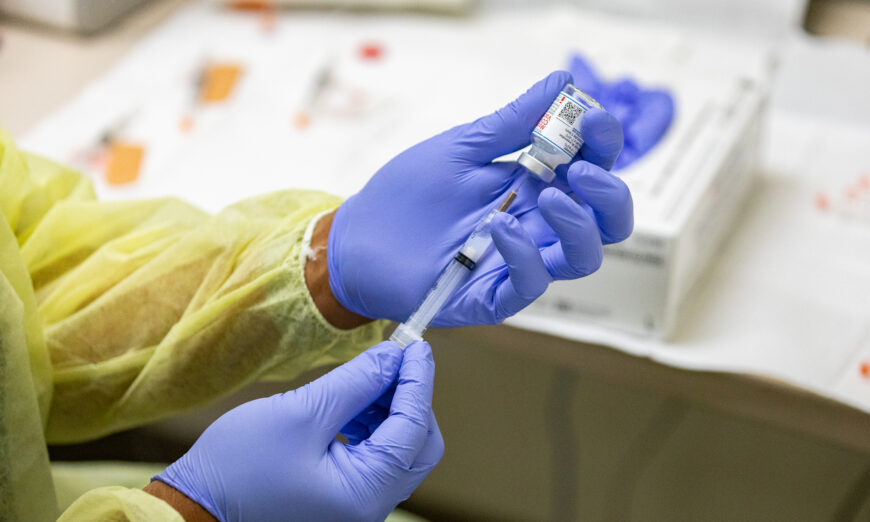 A health care worker prepares a Moderna COVID-19 vaccine at Lestonnac Health Clinic in Orange, Calif., on March 9, 2021. (John Fredricks/The Epoch Times)