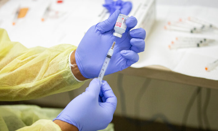 A healthcare worker prepares the Moderna coronavirus vaccination at Lestonnac Health Clinic in Orange, Calif., on March 9, 2021. (John Fredricks/The Epoch Times)