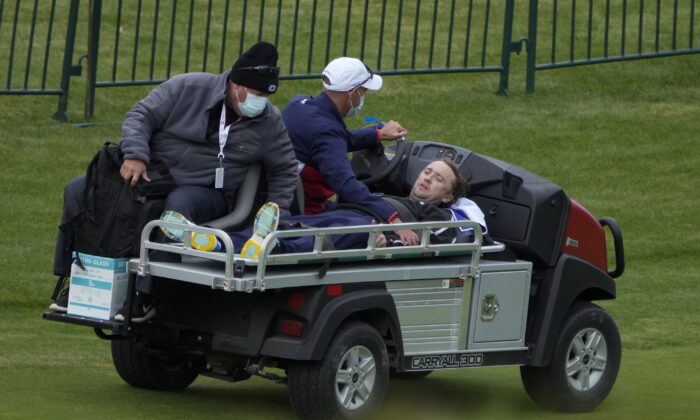 Actor Tom Felton is helped after collapsing on the 18th hole during a practice day at the Ryder Cup at the Whistling Straits Golf Course in Sheboygan, Wis., on Sept. 23, 2021. (Ashley Landis/AP Photo)