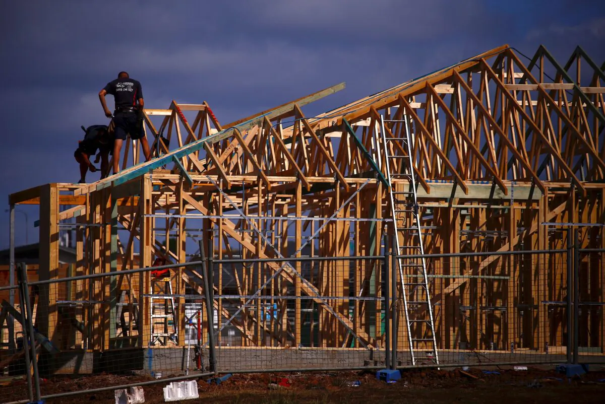 Tradesmen can be seen working on the roof of a house under construction at a housing development located in the western Sydney suburb of Oran Park in Australia on Oct. 21, 2017. (David Gray/Reuters)