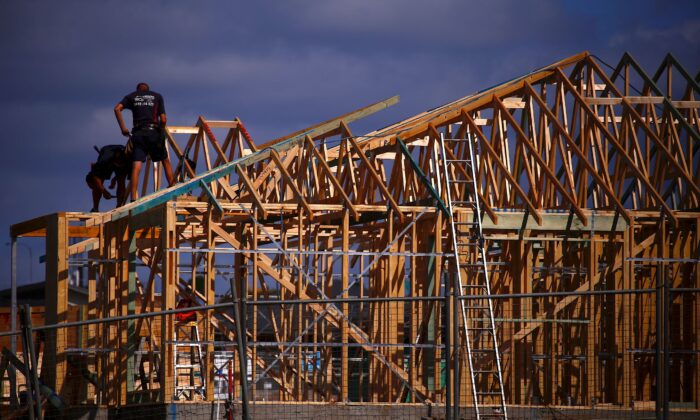 Tradesmen can be seen working on the roof of a house under construction at a housing development located in the western Sydney suburb of Oran Park in Australia on Oct. 21, 2017. (David Gray/Reuters)