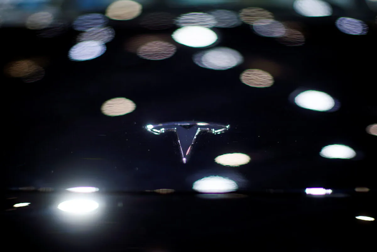 A Tesla logo is seen on the body of its electric vehicle during a media day for the Auto Shanghai show in Shanghai, China, on April 20, 2021. (Aly Song/Reuters)