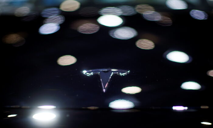 A Tesla logo is seen on the body of its electric vehicle during a media day for the Auto Shanghai show in Shanghai, China, on April 20, 2021. (Aly Song/Reuters)