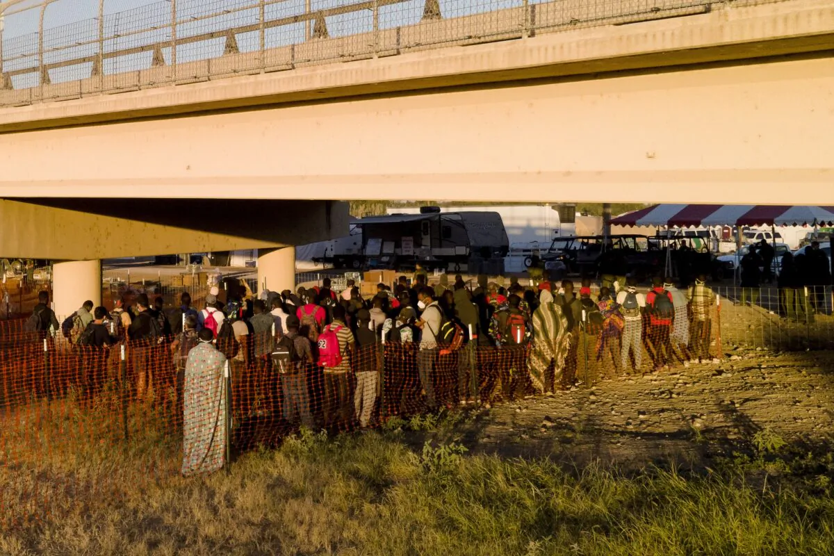 Illegal immigrants, many from Haiti, wait in lines to board buses under the Del Rio International Bridge, in Del Rio, Texas on Friday, Sept. 24, 2021. (Julio Cortez/AP Photo)