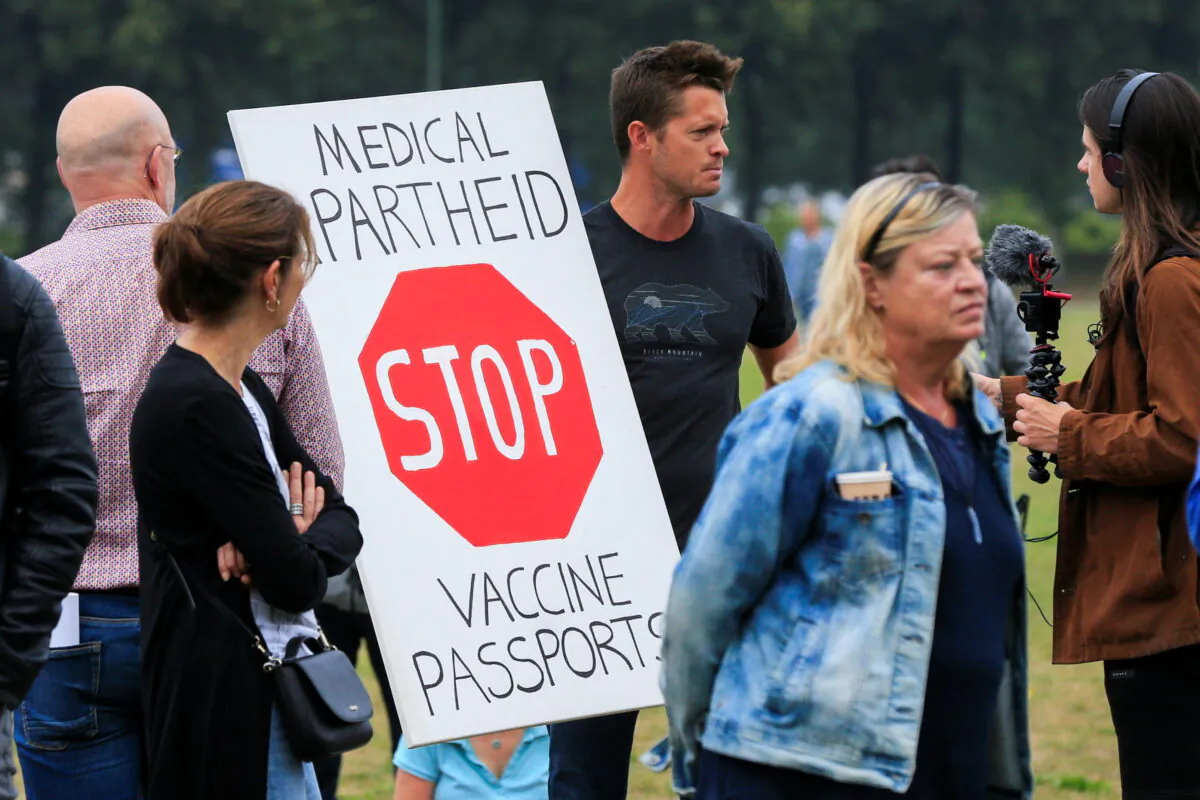 People take part in a protest on the day the Dutch authorities introduce a mandatory "corona pass", proof of the coronavirus disease (COVID-19) vaccination or a negative test result, to enter bars, restaurants, and cultural events in the country, in The Hague, Netherlands, on Sept. 25, 2021. (Eva Plevier/Reuters)