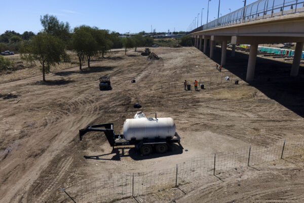 Crews clear an area used by migrants