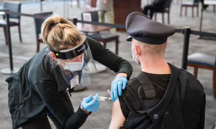 A police officer receives his COVID-19 vaccination at in Foxborough, Mass., on Jan.15, 2021. (Scott Eisen/Getty Images)