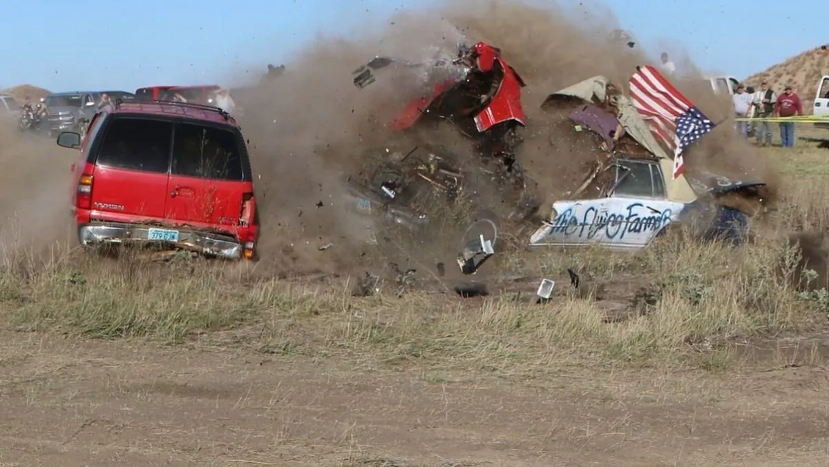 Daredevil John Smith, known as the Flying Farmer, crashes his Chevrolet Caprice while attempting a jump, in Makoti, N.D., on Sept. 25, 2021. (Hunter Andes/The Bismarck Tribune via AP)