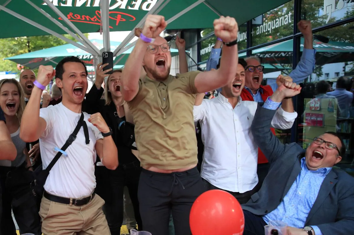 Social Democratic Party (SPD) supporters react after first exit polls for the general elections in Berlin, Germany, on Sept. 26, 2021. (Wolfgang Rattay/Reuters)