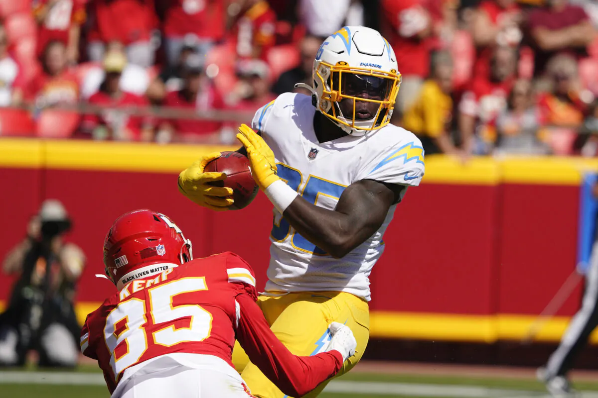 Los Angeles Chargers' Larry Rountree III (35) is tackled by Kansas City Chiefs' Marcus Kemp (85) during the first half of an NFL football game in Kansas City, Mo., on Sept. 26, 2021. (AP Photo/Ed Zurga)