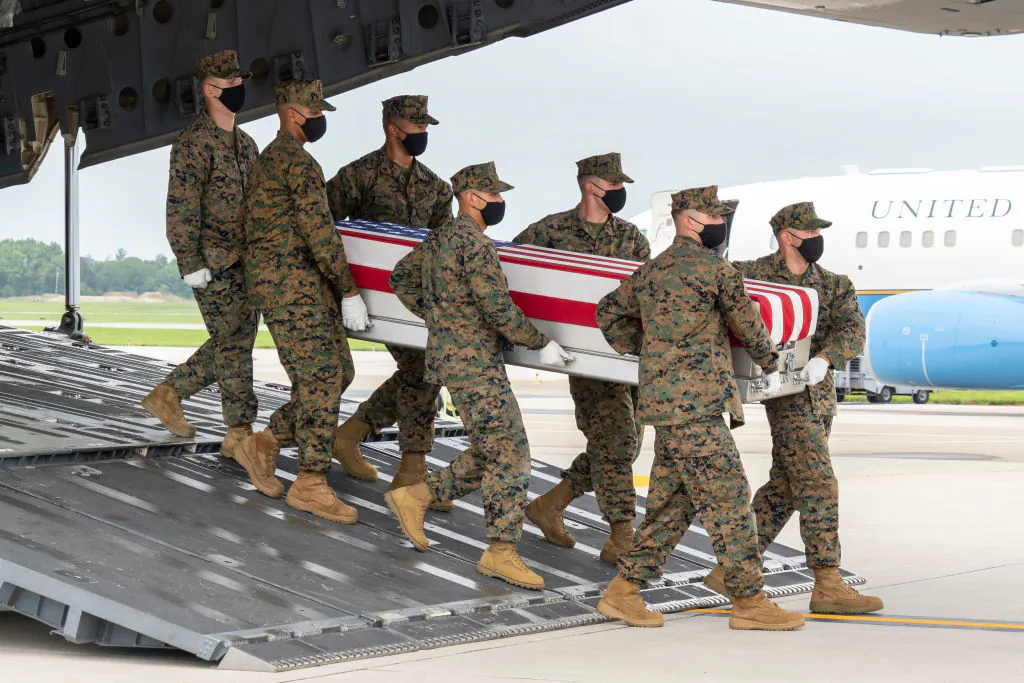 A U.S. Marine Corps carry team transfers the remains of Marine Corps Lance Cpl. Dylan R. Merola of Rancho Cucamonga, Calif., Aug. 29, 2021, at Dover Air Force Base, Delaware. Merola was assigned to 2nd Battalion, 1st Marine Regiment, 1st Marine Division, I Marine Expeditionary Force, Camp Pendleton, Calif. (Jason Minto/U.S. Air Force via Getty Images)