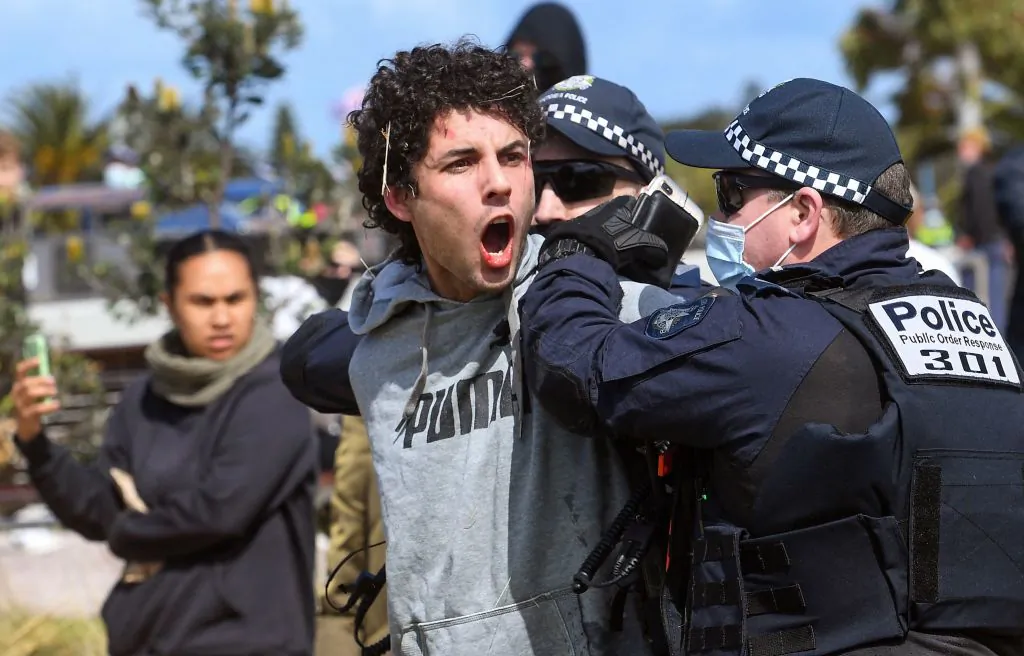 Police arrest a protester at St Kilda in Melbourne on Sept.25, 2021, during an anti-lockdown rally. (William West/AFP via Getty Images)