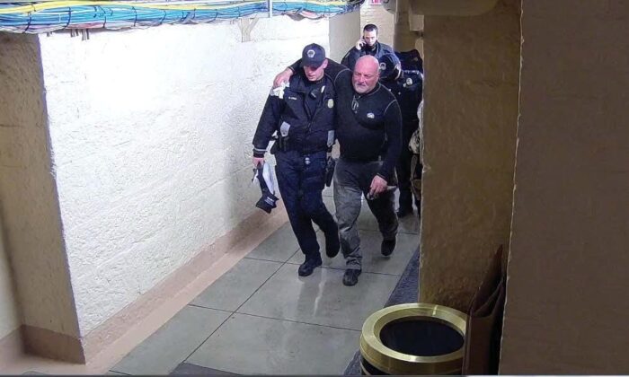 John Anderson is seen being helped by police officers after being pepper sprayed in Washington on Jan. 6, 2021. (FBI)
