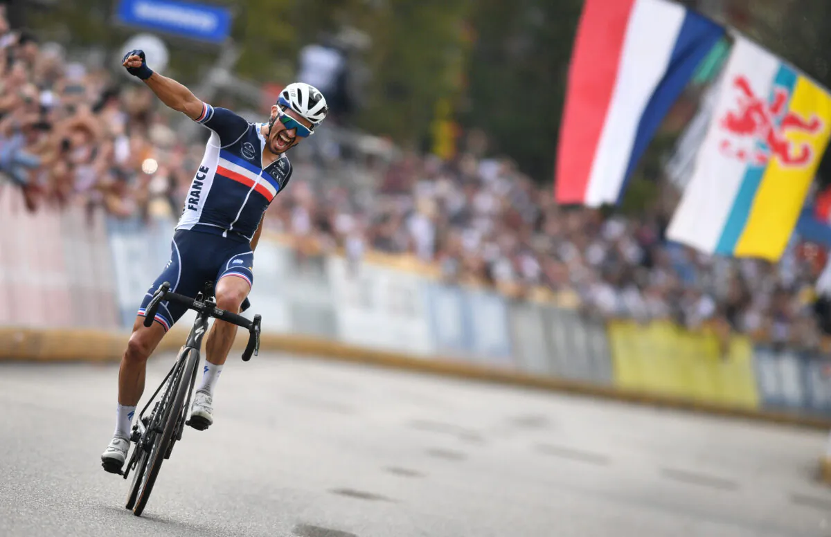 France's Julian Alaphilippe celebrates as he crosses the finish line to win the elite men road race of the UCI World Championships Road Cycling Flanders 2021, 268,3km from Antwerp to Leuven on Sept. 26, 2021. (David Stockman/Belga Mag/AFP via Getty Images)