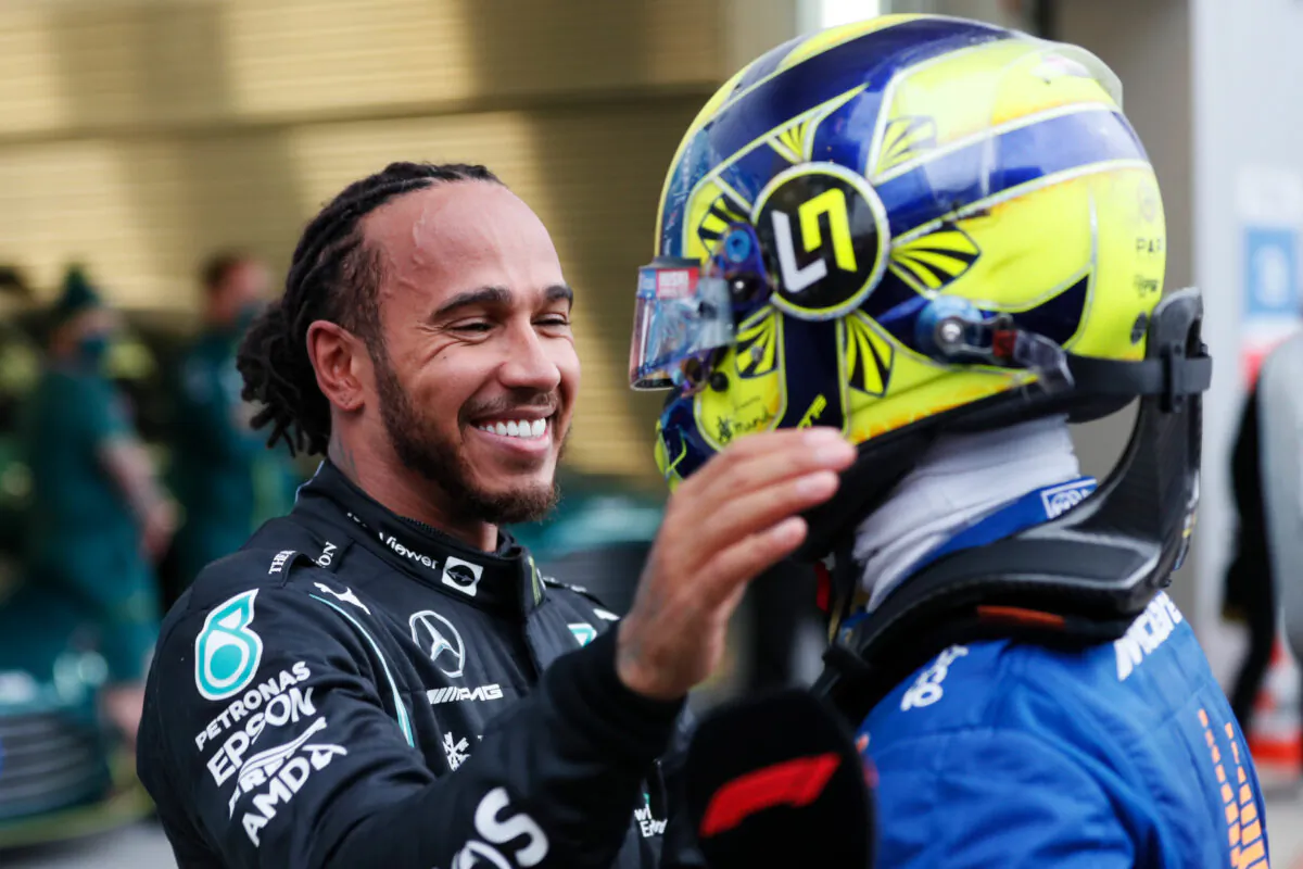 Race winner Lewis Hamilton of Great Britain and Mercedes GP hugs Lando Norris of Great Britain and McLaren F1 in parc ferme during the F1 Grand Prix of Russia at Sochi Autodrom in Sochi, Russia, on Sept. 26, 2021. (Yuri Kochetkov/Getty Images)