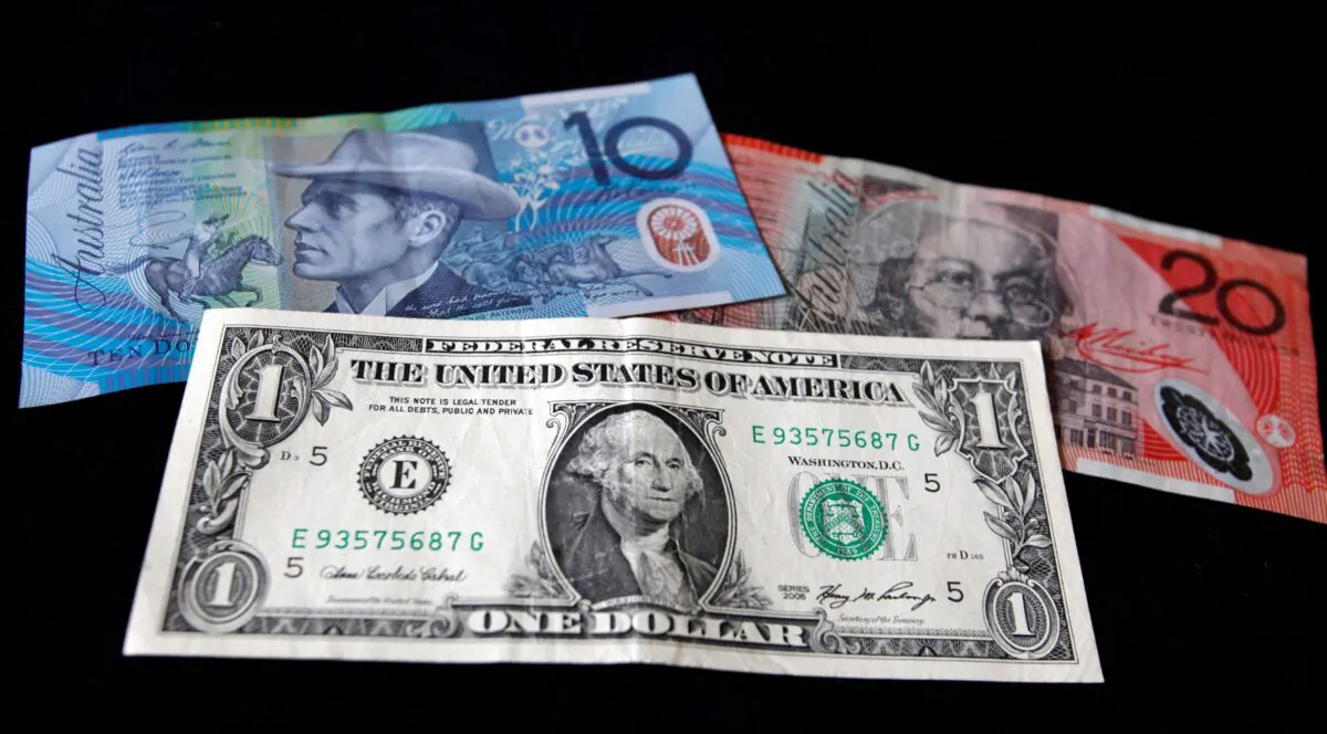 A U.S. dollar note (bottom) is pictured alongside an Australian 10 dollar (L) and 20 dollar bill in this picture illustration taken in Washington on Oct. 14, 2010. (Jason Reed/Reuters)