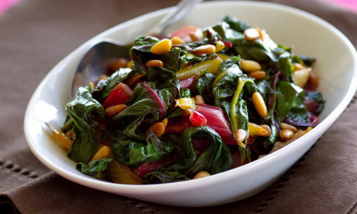 This simply sautéed side dish includes rice wine vinegar for tartness and toasted pine nuts for creaminess. (Ben Fink/TNS)
