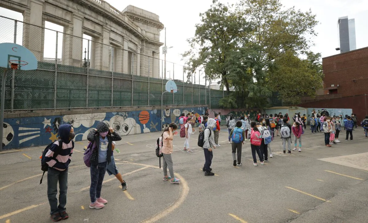 Masked students line up in the morning at Yung Wing School P.S. 124 in New York City on Sept. 27, 2021. (Michael Loccisano/Getty Images)