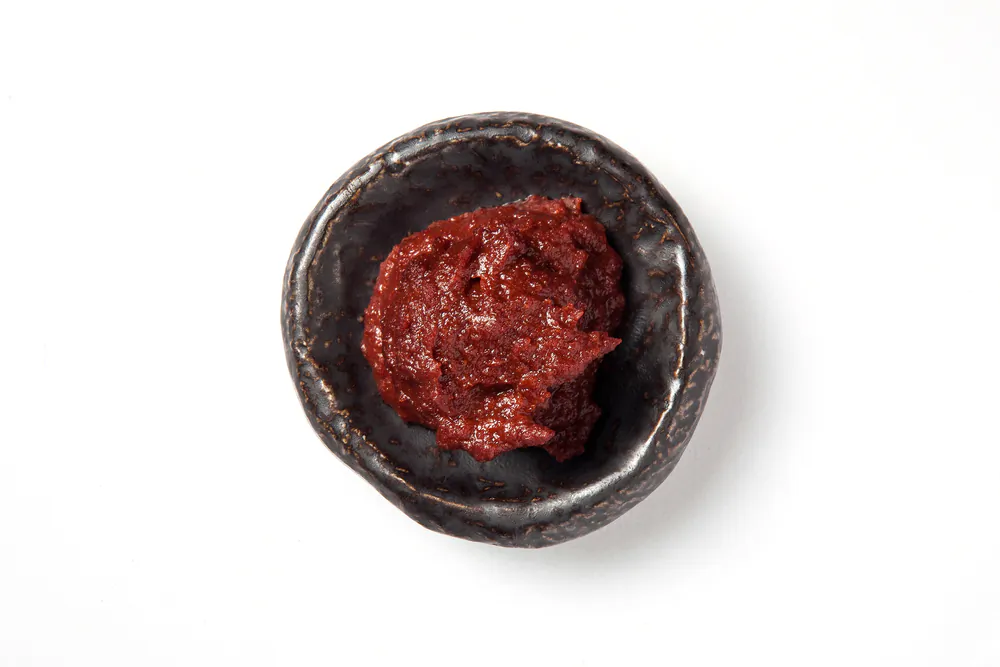 Gochujang is a flavor bomb of a condiment, made from chile peppers, glutinous rice, and fermented soybeans. (changrak/Shutterstock)