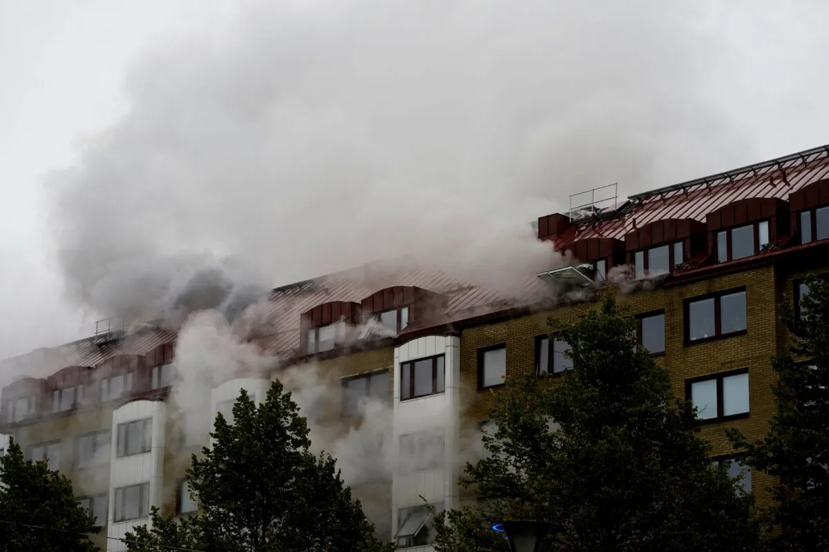 Smoke comes out of windows after an explosion hit an apartment building in Annedal, central Gothenburg, Sweden, on Sept. 28, 2021. (Larsson Rosvall/TT News Agency via Reuters)