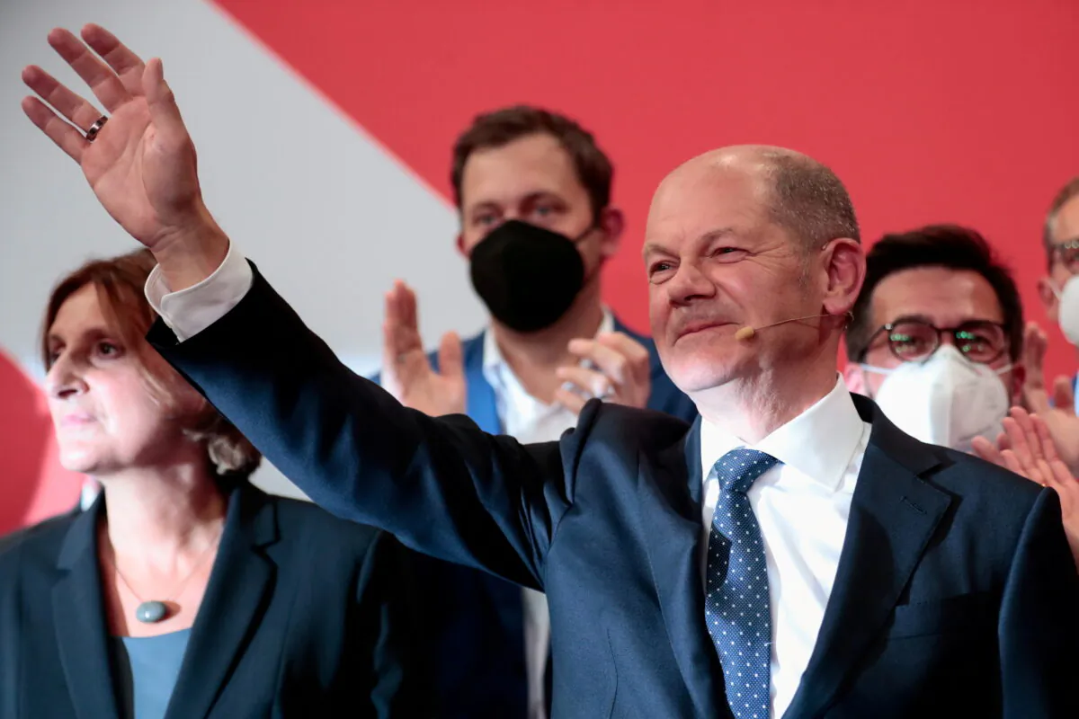 Social Democratic Party (SPD) top candidate for chancellor Olaf Scholz waves after first exit polls for the general elections in Berlin, Germany, on Sept. 26, 2021.  (Hannibal Hanschke/Reuters)