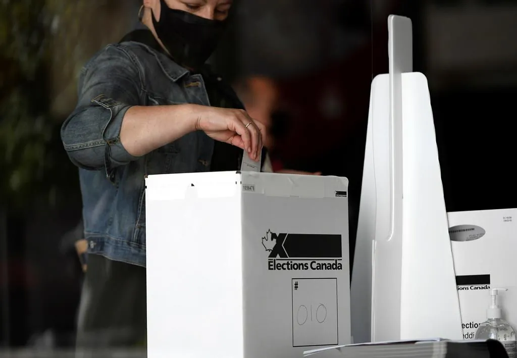 A voter casts their ballot at a polling location on election day during the 44th Canadian general election, on Sept. 20, 2021. (The Canadian Press/Justin Tang)