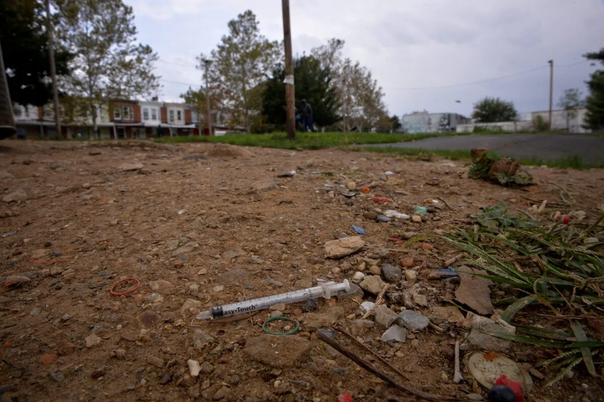 A needle used for shooting heroin litters the ground in a park in the Kensington section of Philadelphia, Pa., on Oct. 26, 2017. (Charles Mostoller/Reuters)