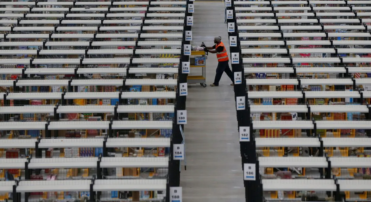 A worker collects orders at Amazon's fulfilment centre in Rugeley, central England on Dec. 11, 2012. (Phil Noble/Reuters)