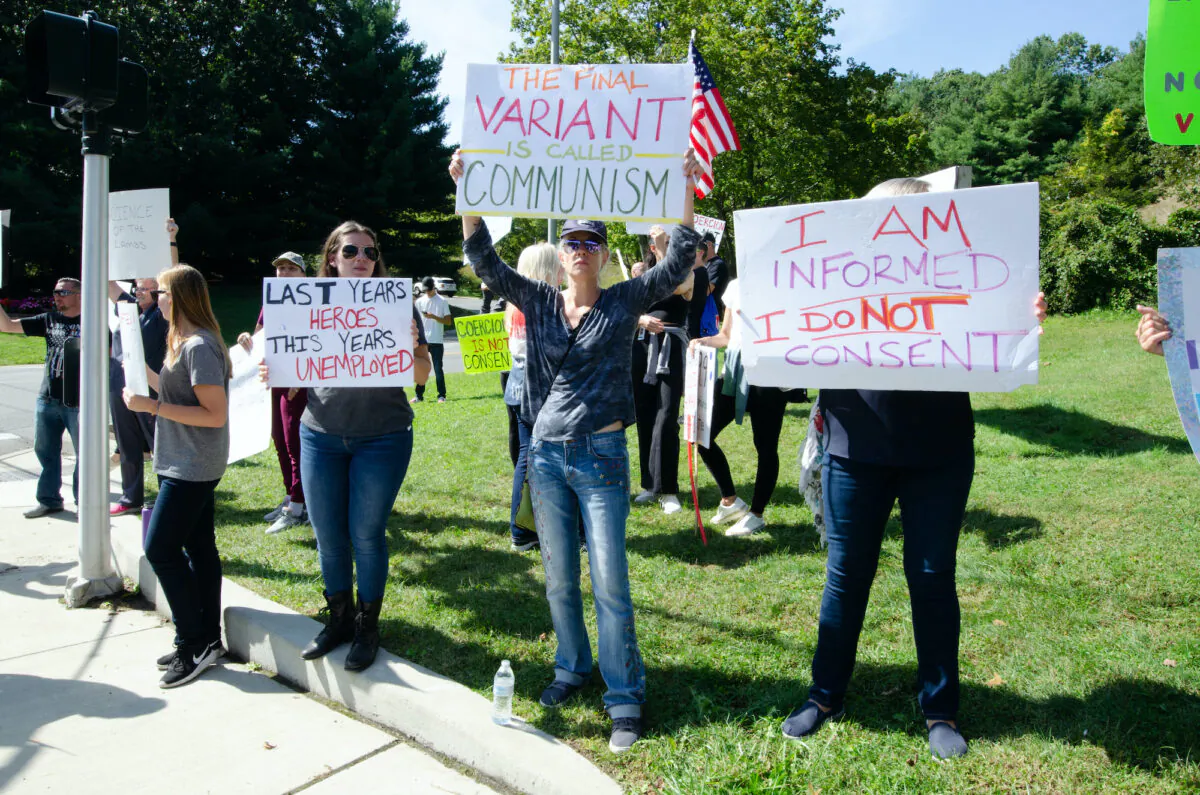 Protesters against a COVID-19 vaccine mandate in New York State hold signs outside the St. Catherine of Siena Medical Center in Smithtown, Long Island, on Sept. 27. (Dave Paone/The Epoch Times)