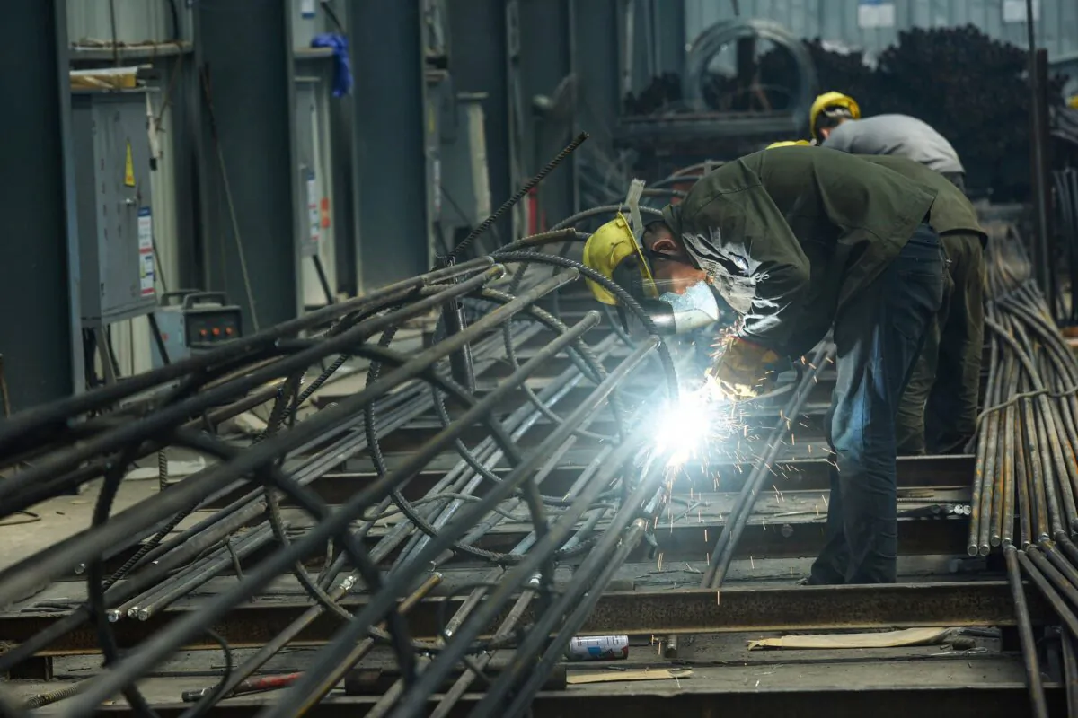 An employee works on steel bars at a factory in Hangzhou, in China's eastern Zhejiang Province on May 15, 2020. (STR/AFP)