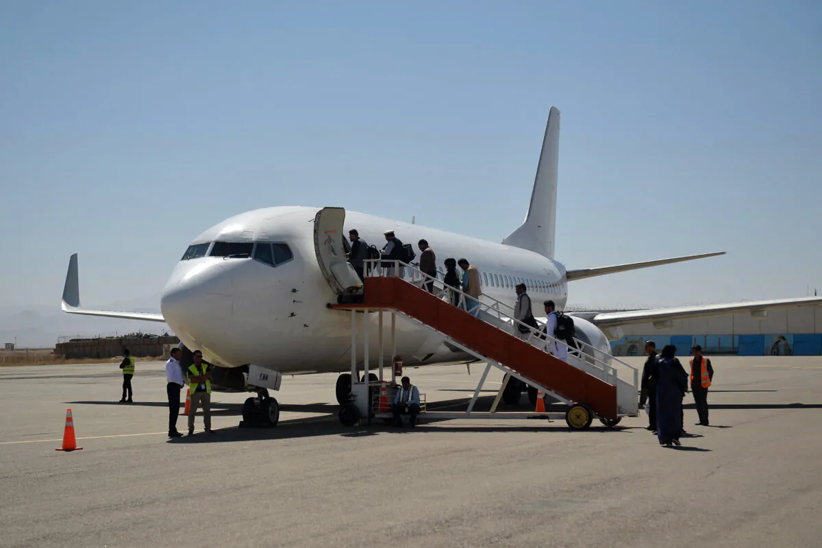 Passengers board a commercial aircraft bound to Kabul at Herat Airport in Afghanistan on Sept. 22, 2021. (Hoshang Hashimi/AFP via Getty Images)