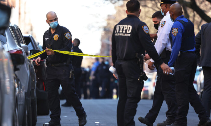 NYPD officers respond to the scene of a shooting that left multiple people injured in the Flatbush neighborhood of the Brooklyn borough on April 6, 2021.  (Michael M. Santiago/Getty Images)