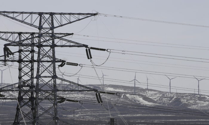 Power lines and wind turbines are pictured at a wind and solar energy storage and transmission power station of State Grid Corporation of China, in Zhangjiakou of Hebei Province, China, on March 18, 2016. (Jason Lee/Reuters)