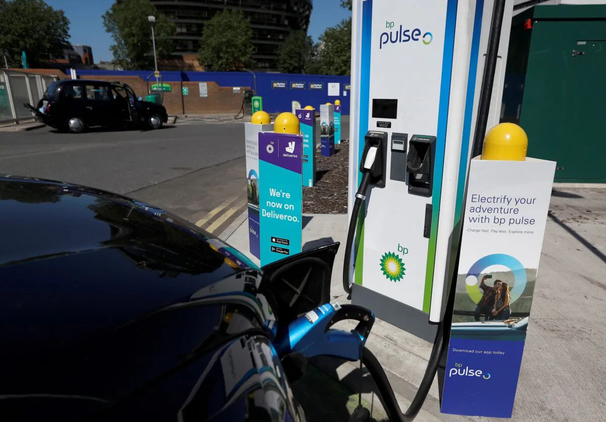 An electric taxi is seen being charged at a BP Pulse electric vehicle charging point in London on July 16, 2021. (Peter Nicholls/Reuters)