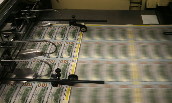 One-hundred-dollar notes are printed at the Bureau of Engraving and Printing in Washington in this file photo. (Mark Wilson/Getty Images)