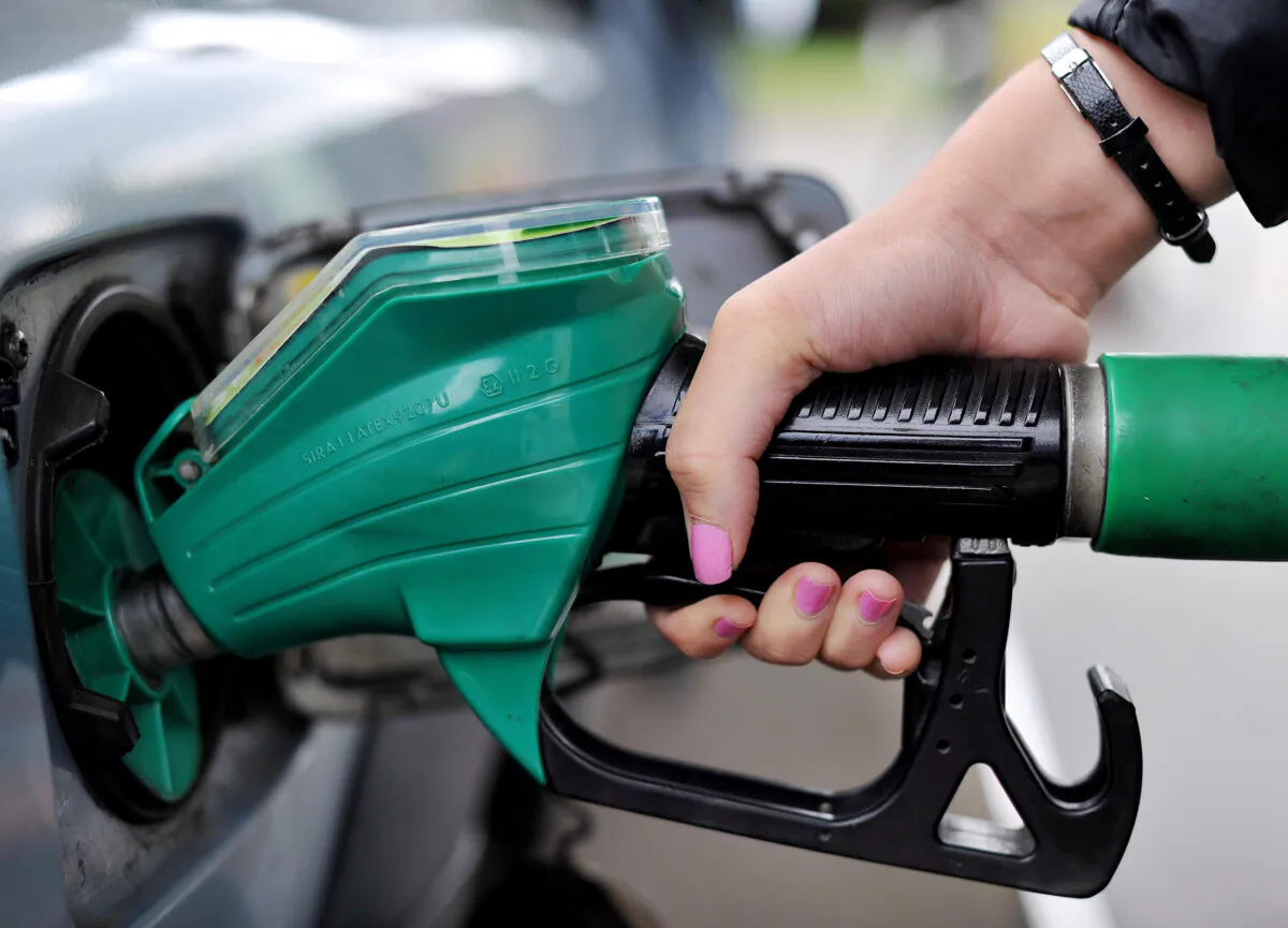 A person using a petrol pump in a file photo dated Aug. 15, 2013. (Nick Ansell/PA)