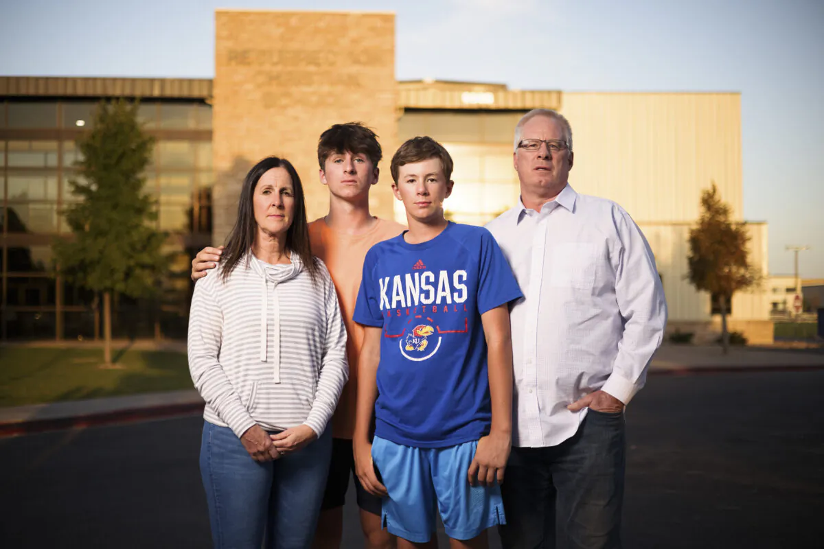 Karen Riggs and her husband, Mike Riggs, stand with their sons, Resurrection Christian School junior Charlie Riggs, 16 (2nd L), and freshman Graham Riggs, 13, outside the school in Loveland, Colo., on Sept. 27, 2021. (Michael Ciaglo for the Epoch Times)
