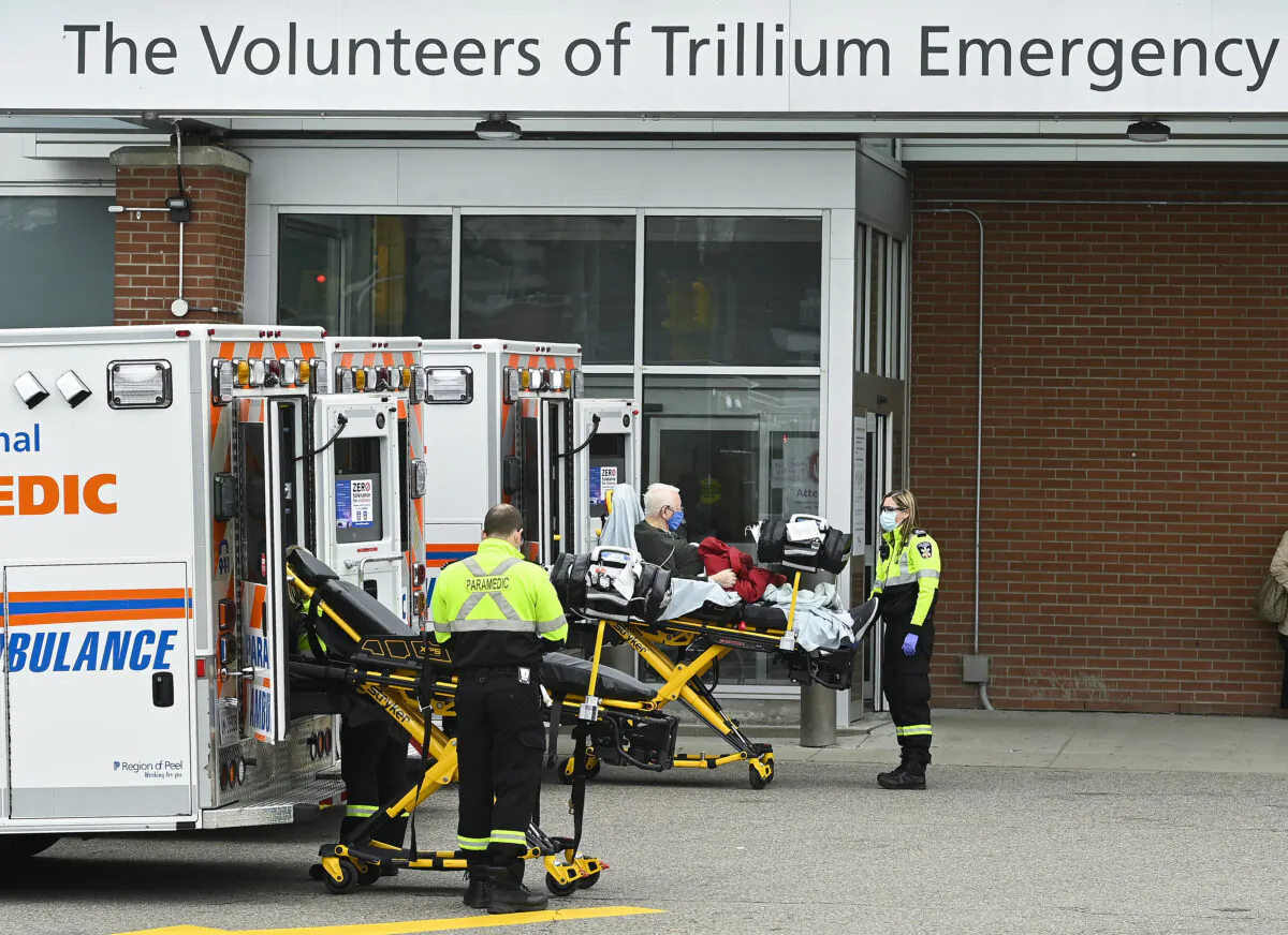 Paramedics transport an elderly man to a hospital emergency department in Mississauga, Ont., on Nov. 19, 2020. (The Canadian Press/Nathan Denette)